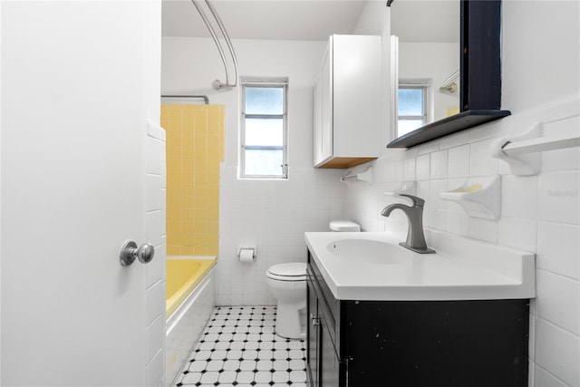 full bathroom with vanity,  shower combination, tile walls, tile patterned flooring, and toilet