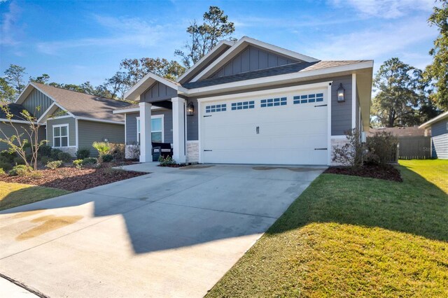 craftsman-style home with a front yard and a garage