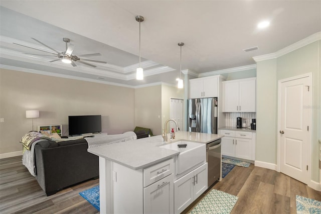 kitchen featuring sink, white cabinetry, an island with sink, and appliances with stainless steel finishes