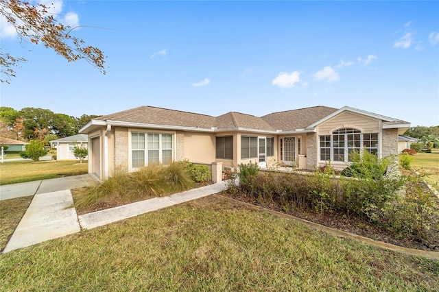 ranch-style home with a front yard and a garage