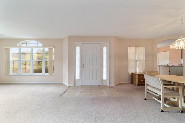 foyer entrance with light colored carpet