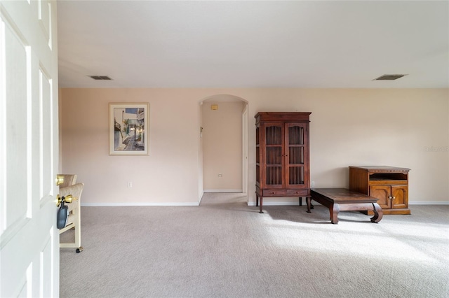 sitting room featuring light colored carpet