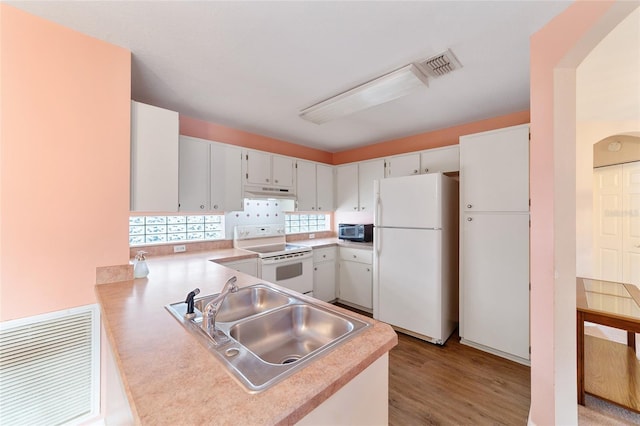 kitchen featuring sink, white cabinets, light hardwood / wood-style floors, and white appliances