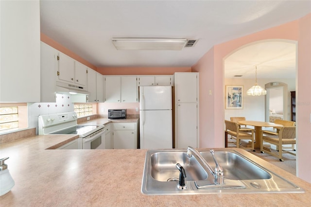 kitchen featuring sink, white cabinets, decorative light fixtures, and white appliances