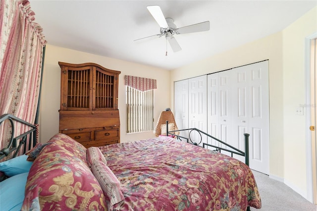 carpeted bedroom featuring ceiling fan and a closet