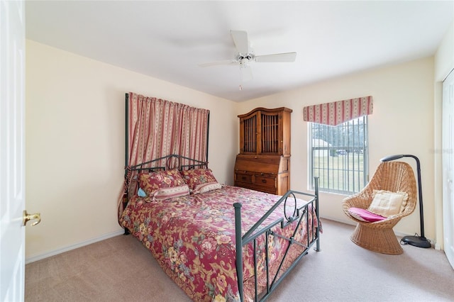 bedroom featuring ceiling fan and light carpet