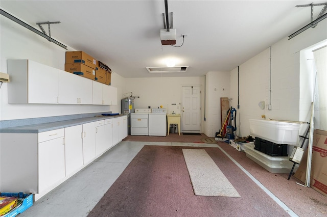 garage with washing machine and clothes dryer, water heater, and a garage door opener