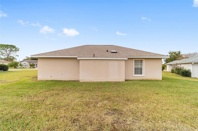 rear view of property with a yard