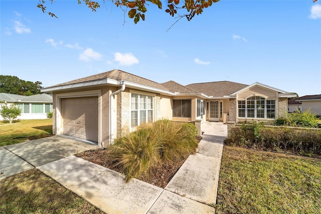 ranch-style home featuring a garage and a front lawn