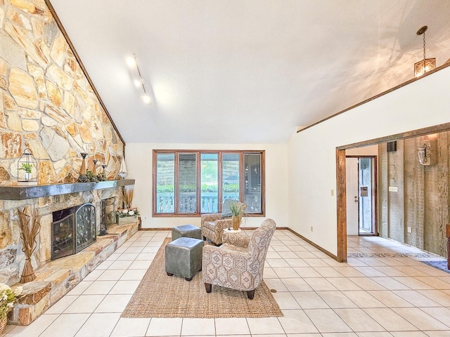 tiled living room featuring vaulted ceiling, a stone fireplace, and a textured ceiling