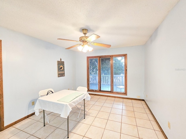 interior space featuring ceiling fan and a textured ceiling