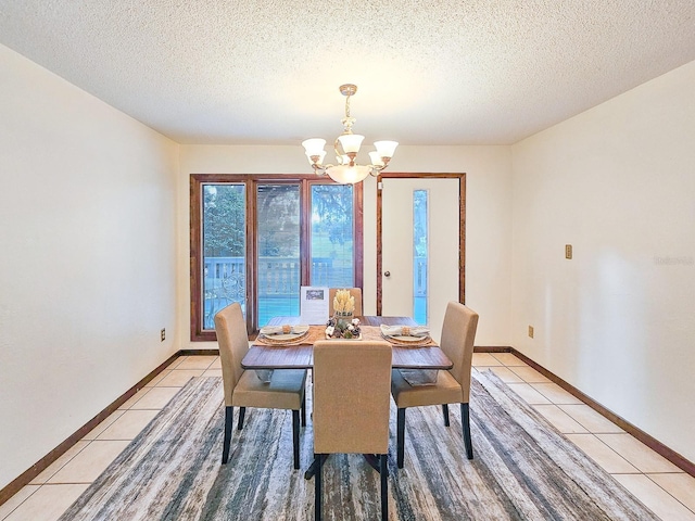 tiled dining space with an inviting chandelier and a textured ceiling