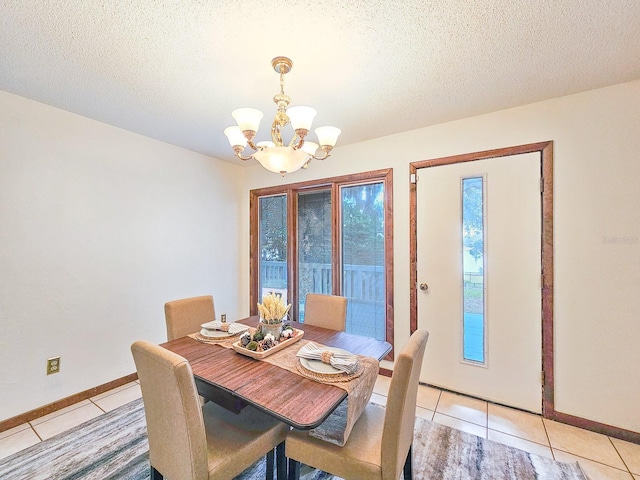 dining room featuring a textured ceiling, a chandelier, and light tile patterned flooring