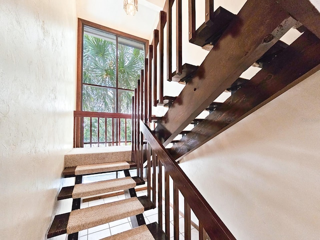 stairway with tile patterned flooring