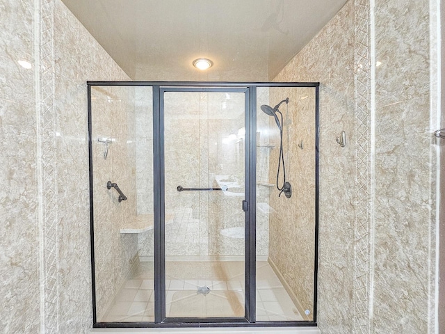 bathroom featuring a shower with shower door