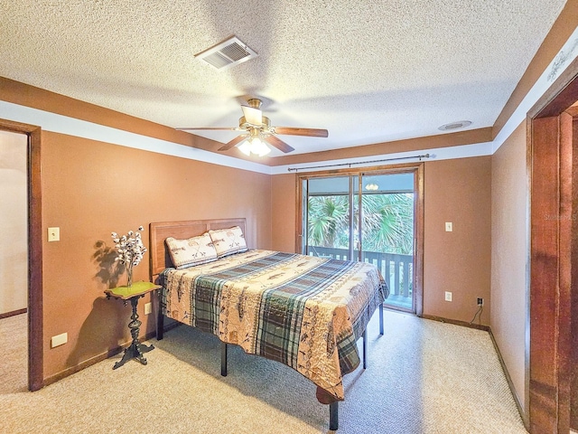 bedroom featuring ceiling fan, access to exterior, light carpet, and a textured ceiling