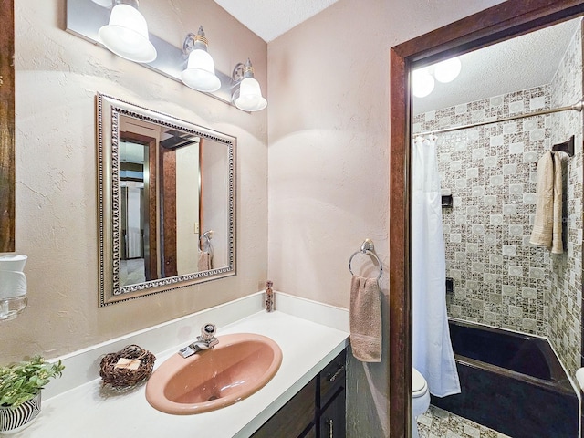 bathroom with vanity, a textured ceiling, and toilet