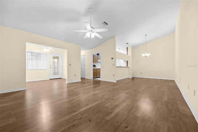 unfurnished living room featuring dark hardwood / wood-style flooring, ceiling fan with notable chandelier, and lofted ceiling