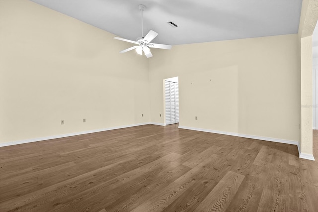 spare room with ceiling fan, wood-type flooring, and vaulted ceiling