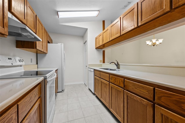 kitchen with vaulted ceiling, sink, white appliances, and an inviting chandelier