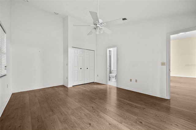 unfurnished room featuring ceiling fan, hardwood / wood-style floors, and high vaulted ceiling