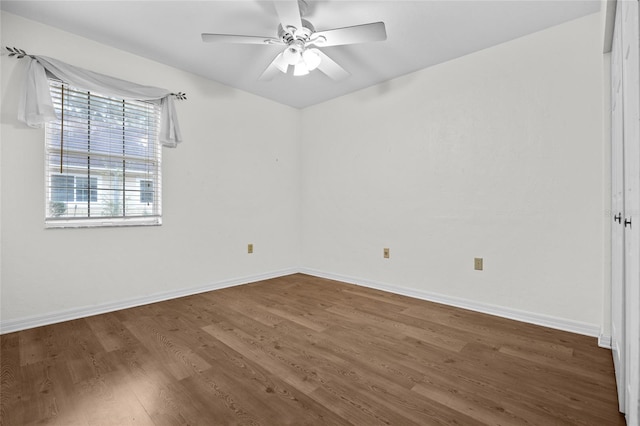 empty room featuring ceiling fan and dark wood-type flooring