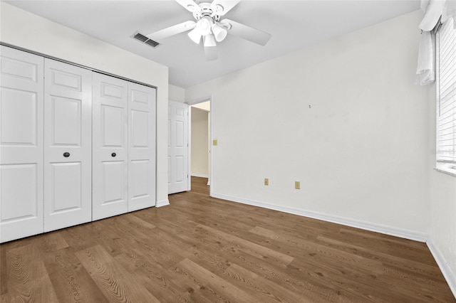 unfurnished bedroom with a closet, ceiling fan, and hardwood / wood-style floors