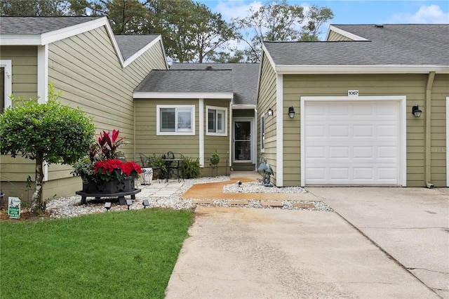 exterior space with a yard and a garage