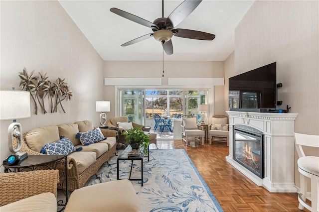 living room with ceiling fan, parquet flooring, and a premium fireplace