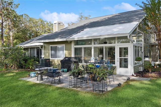 back of house with a patio area, a sunroom, and a yard