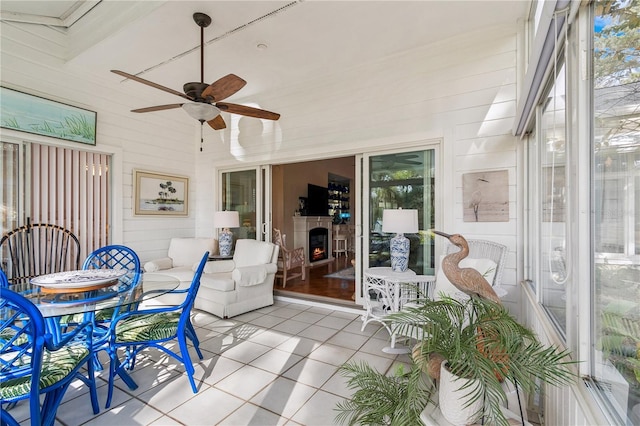 sunroom / solarium featuring ceiling fan