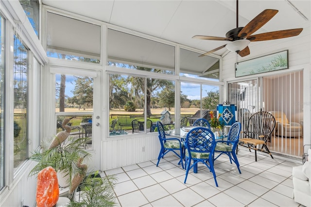 sunroom featuring plenty of natural light, ceiling fan, and lofted ceiling