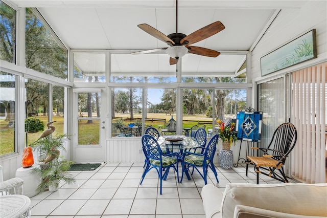 sunroom / solarium with ceiling fan and lofted ceiling