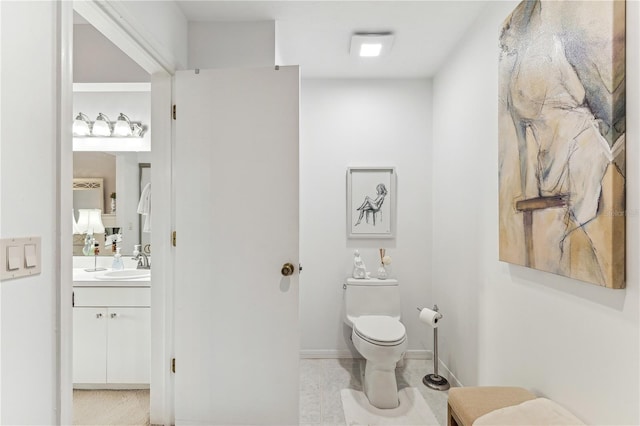 bathroom featuring vanity and toilet