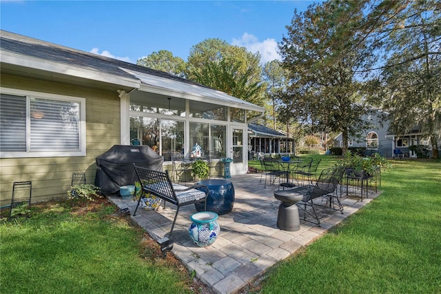 view of patio / terrace with a grill and a sunroom