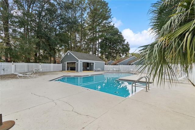 view of pool with a patio area and an outdoor structure