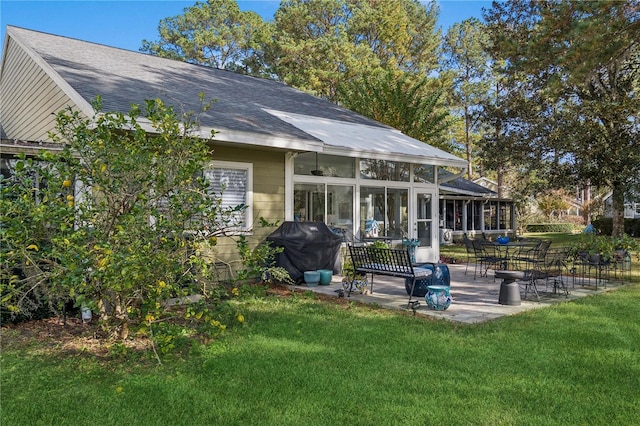 back of house with a yard, a patio area, and a sunroom