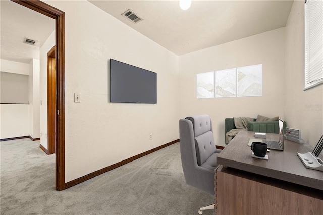 office space featuring light colored carpet and plenty of natural light