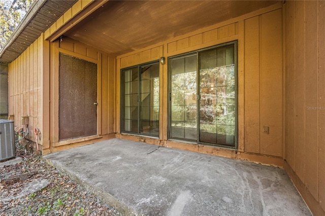 doorway to property with central AC and a patio