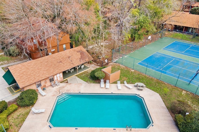 view of pool featuring tennis court