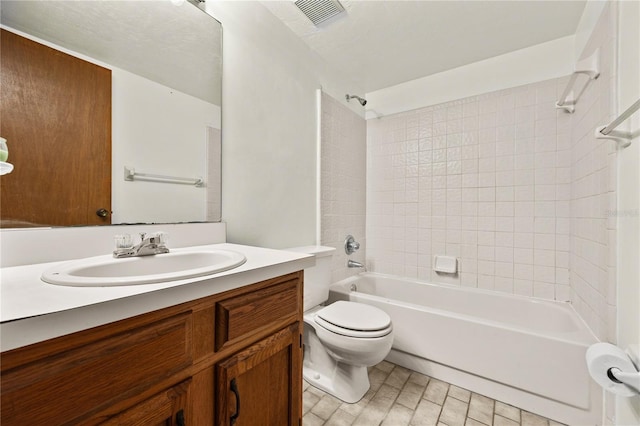 full bathroom featuring vanity, toilet, and tiled shower / bath