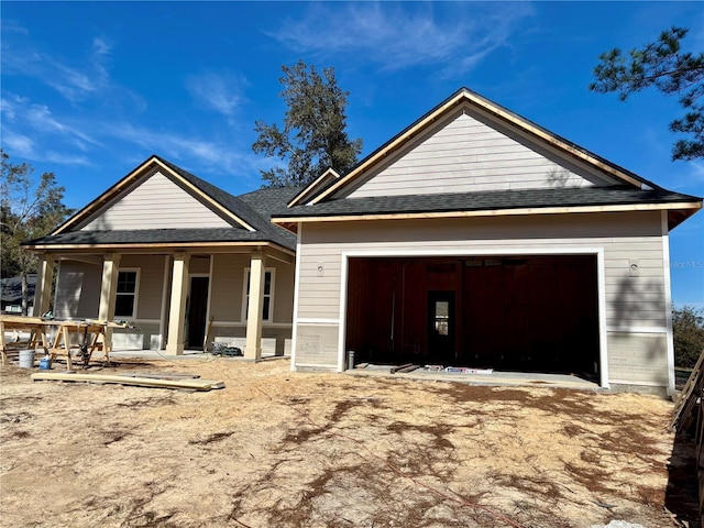 view of front of property with a garage and covered porch