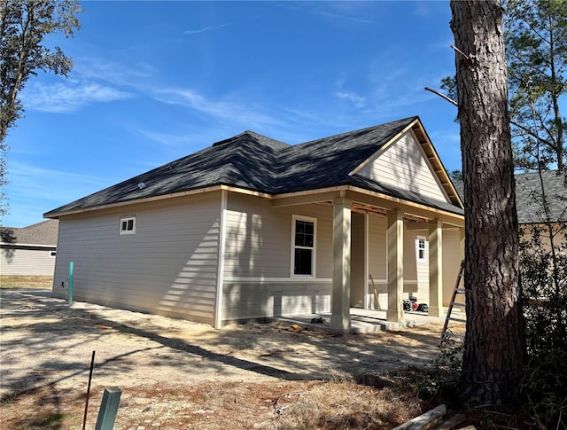 view of side of home with covered porch