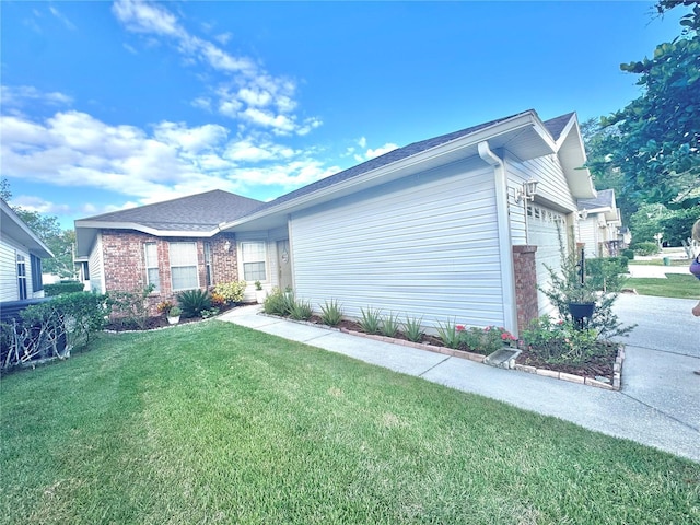 view of property exterior with a garage and a lawn