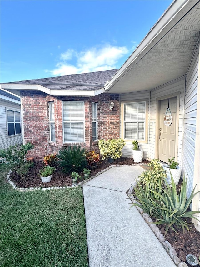 entrance to property with a yard