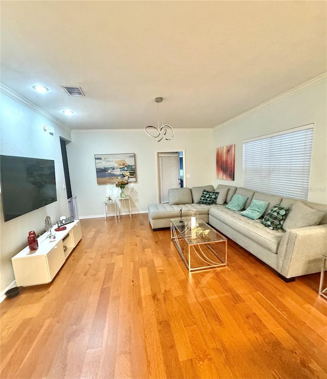 living room featuring crown molding, a chandelier, and hardwood / wood-style flooring