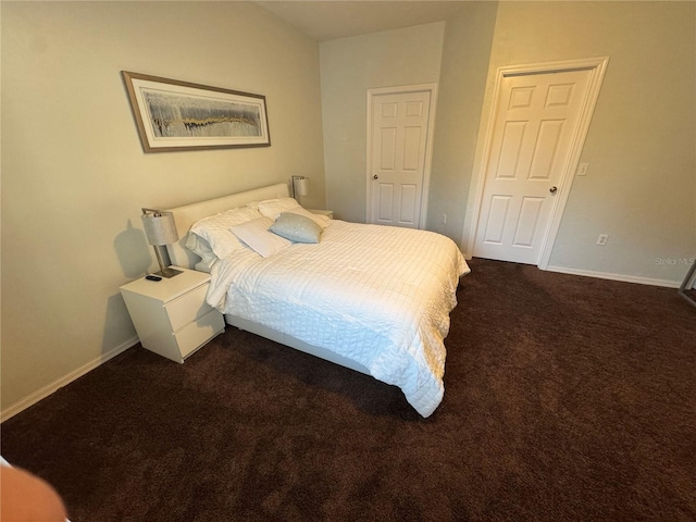 bedroom with dark colored carpet