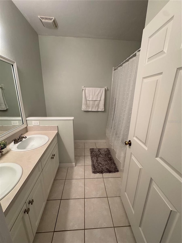 bathroom with tile patterned flooring and vanity