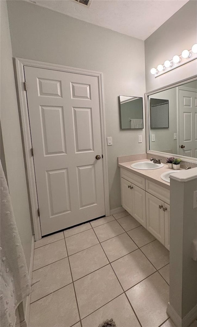 bathroom with tile patterned flooring and vanity