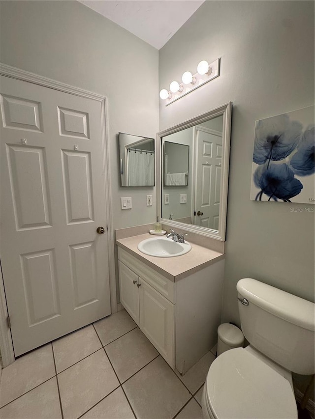 bathroom featuring tile patterned floors, vanity, and toilet